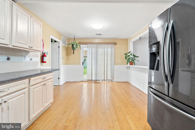 90 Echohill Ln, Willingboro, NJ 08046 - kitchen with stainless steel fridge, light wood finished floors, dark countertops, tasteful backsplash, and a wainscoted wall