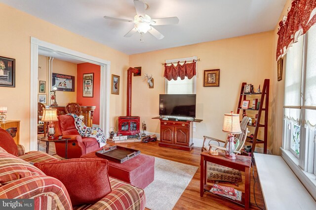 9309 W St, Manassas, VA 20110 - living room with a wood stove, a ceiling fan, and wood finished floors