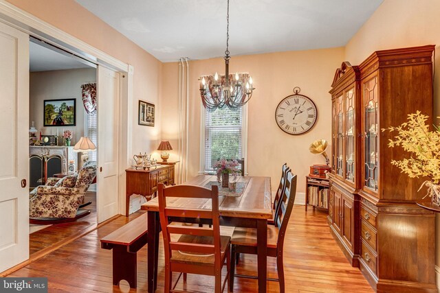 9309 W St, Manassas, VA 20110 - dining space featuring light wood-style floors and a chandelier