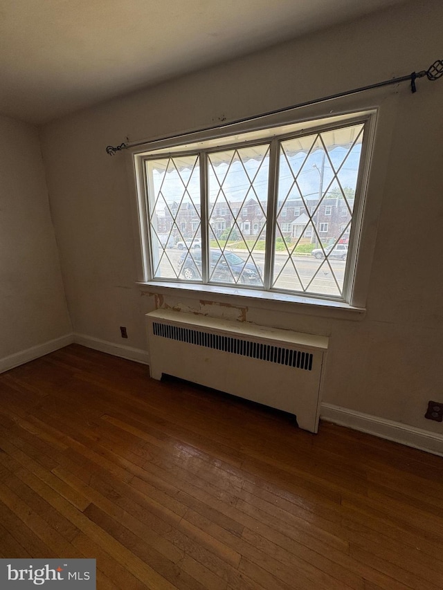 2939 Tyson Ave, Philadelphia, PA 19149 - spare room featuring radiator, hardwood / wood-style floors, and baseboards