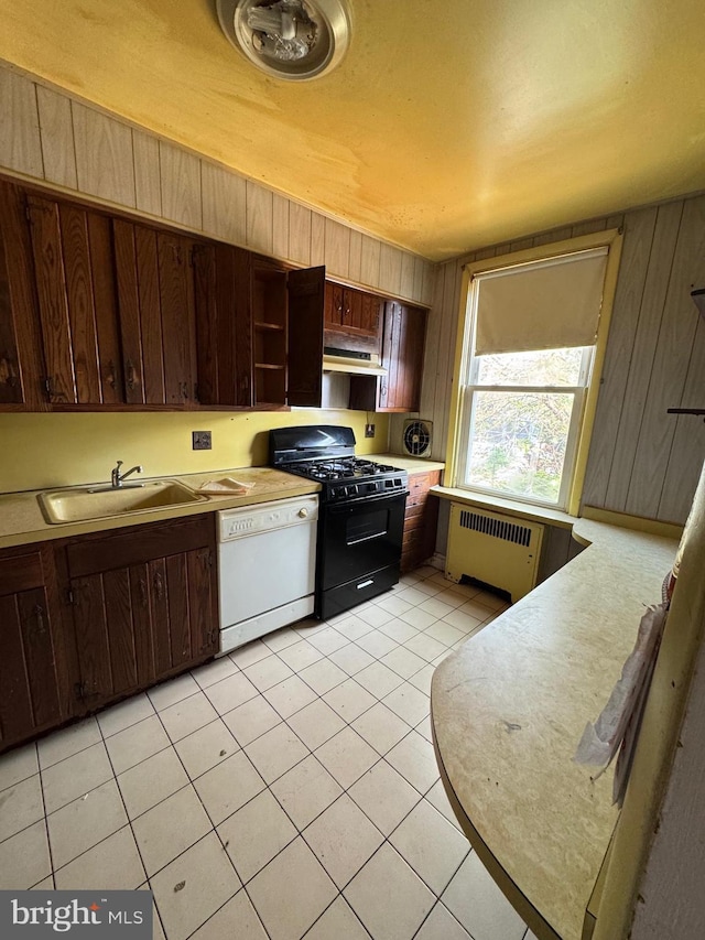 2939 Tyson Ave, Philadelphia, PA 19149 - kitchen with radiator heating unit, dishwasher, black gas range oven, a sink, and light countertops