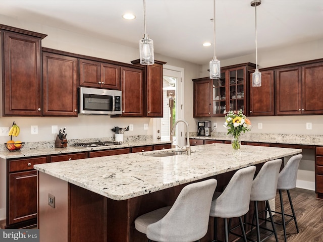 1205 Hickory Hill Cir, Arnold, MD 21012 - kitchen with appliances with stainless steel finishes, a sink, a center island with sink, a kitchen bar, and dark wood-style flooring