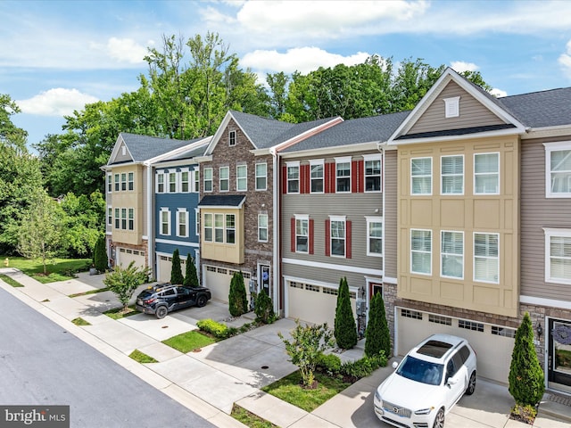 1205 Hickory Hill Cir, Arnold, MD 21012 - townhome / multi-family property with a garage, driveway, a shingled roof, and stone siding