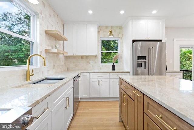 3 Knox Pl, Silver Spring, MD 20901 - kitchen with stainless steel appliances, open shelves, white cabinets, decorative backsplash, and light stone countertops