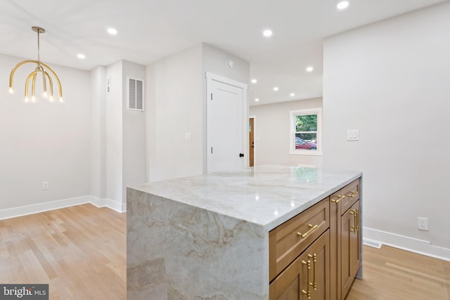 3 Knox Pl, Silver Spring, MD 20901 - kitchen with light wood-style flooring, light stone countertops, pendant lighting, recessed lighting, and a chandelier
