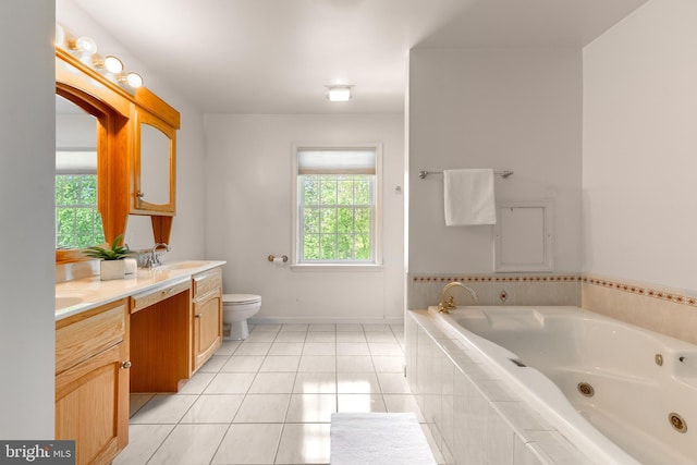 bathroom with a jetted tub, toilet, double vanity, tile patterned floors, and baseboards