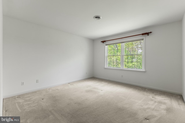 empty room with carpet flooring and baseboards