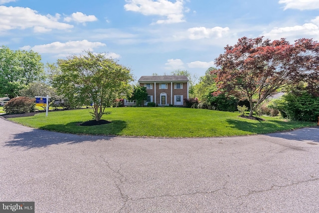 colonial-style house with a front yard