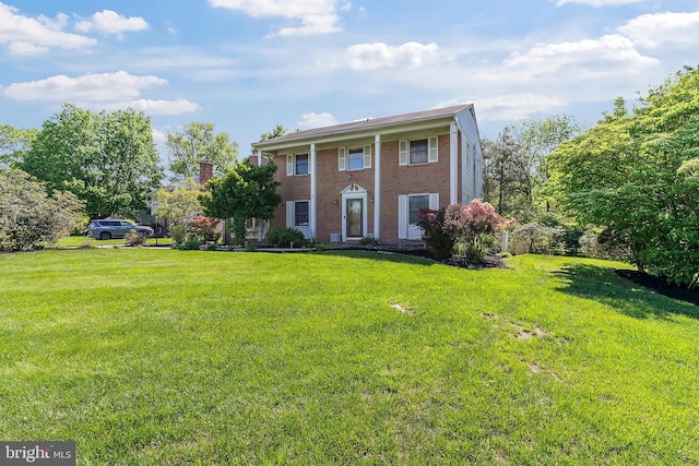 view of front of property with brick siding and a front yard