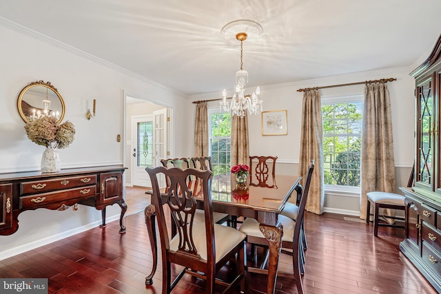 dining area featuring a chandelier, dark wood-style flooring, healthy amount of natural light, and crown molding
