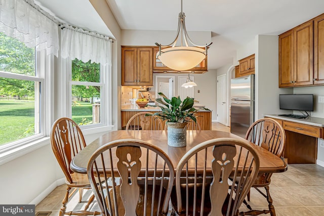 dining area featuring baseboards and light tile patterned flooring