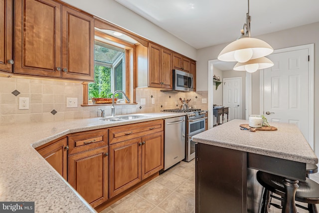 kitchen with a sink, appliances with stainless steel finishes, and brown cabinetry