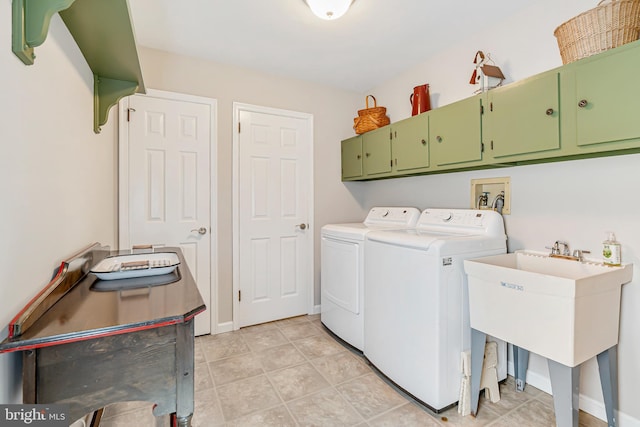 washroom with cabinet space, washer and clothes dryer, and baseboards