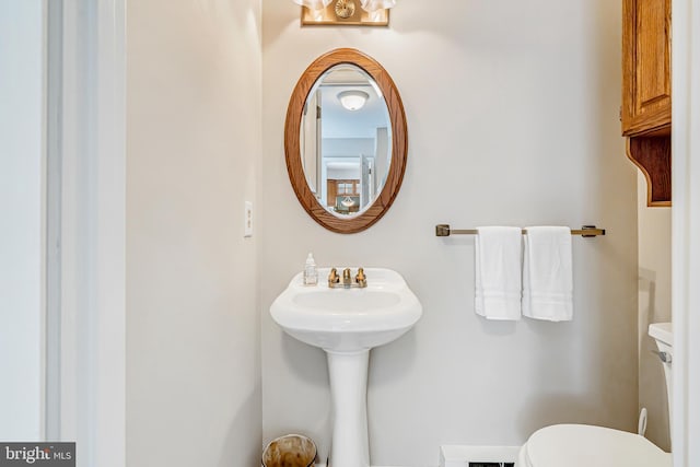 half bathroom with toilet and a sink