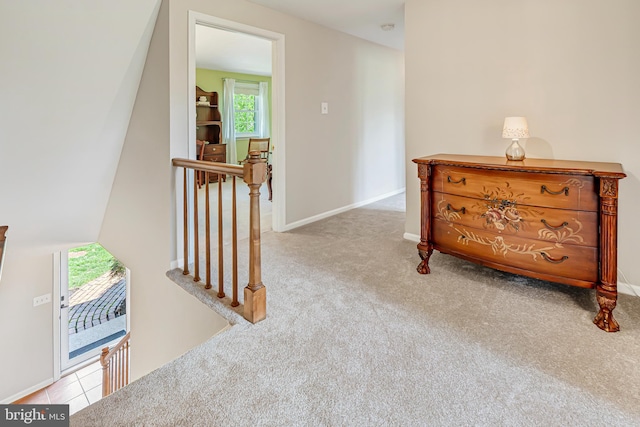 hallway with light carpet and baseboards