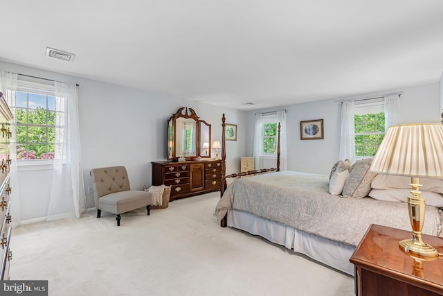 carpeted bedroom with multiple windows and baseboards