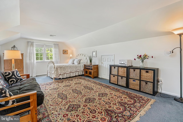 bedroom with carpet flooring and vaulted ceiling