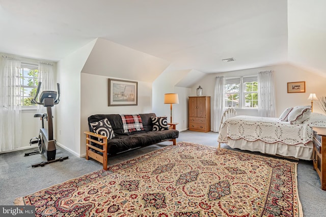 carpeted bedroom featuring lofted ceiling and baseboards