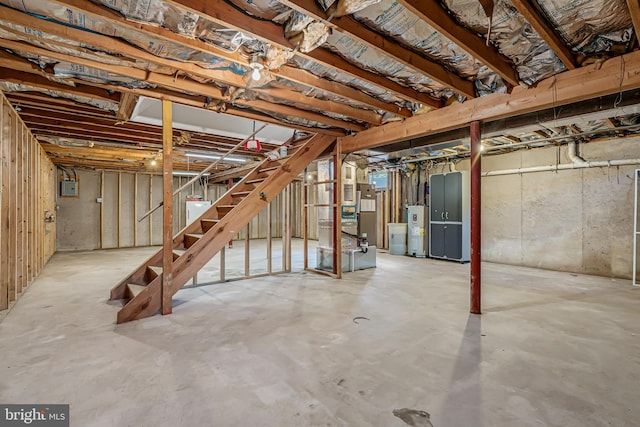 unfinished below grade area featuring water heater, stairs, heating unit, and electric panel