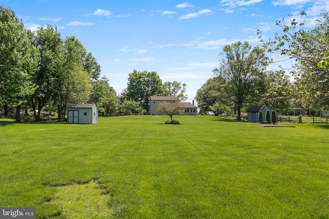 view of green lawn featuring a storage unit and an outdoor structure