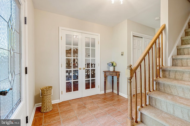 foyer entrance featuring stairway, french doors, and baseboards