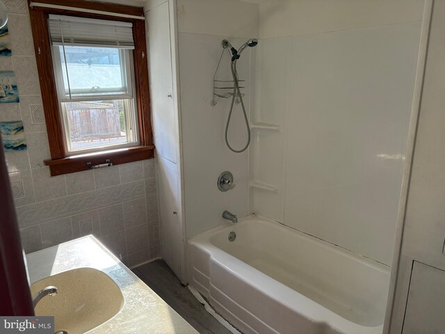 bathroom with a sink and shower / bathtub combination