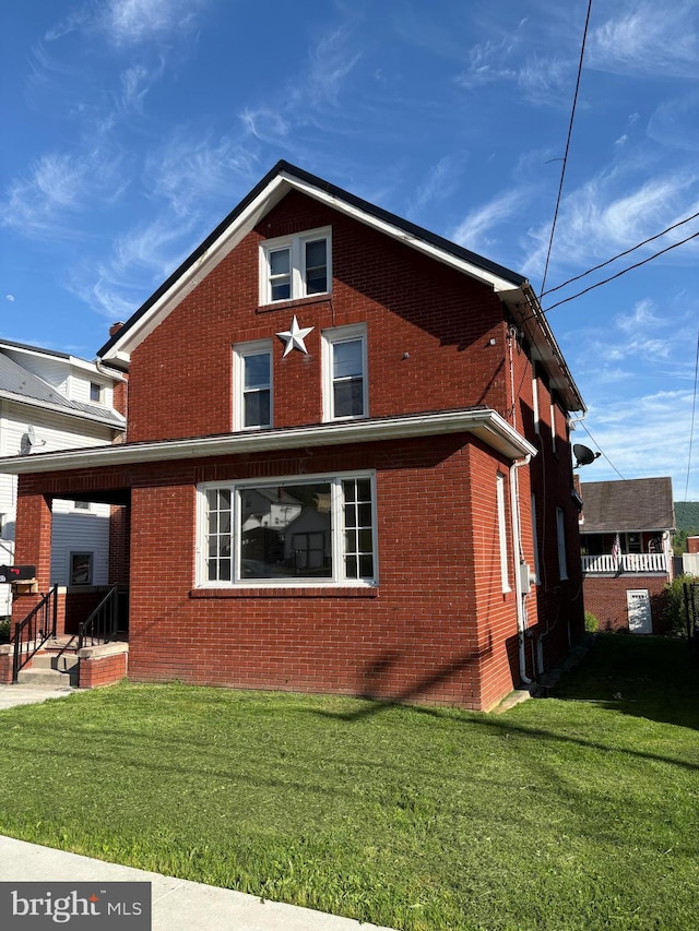 view of property exterior featuring brick siding and a lawn