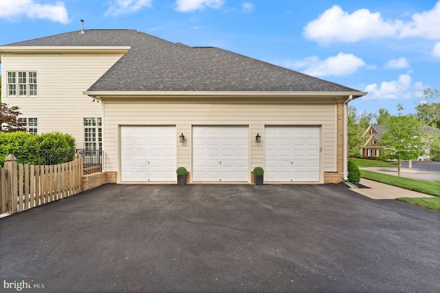18729 Upper Meadow Dr, Leesburg, VA 20176 - garage with asphalt driveway and fence