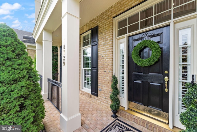18729 Upper Meadow Dr, Leesburg, VA 20176 - doorway to property with brick siding and a porch