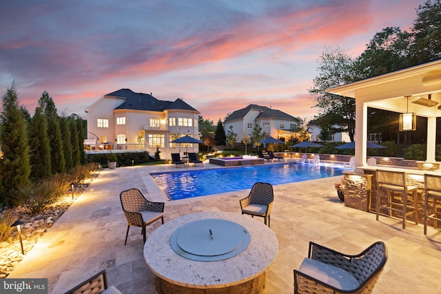 18729 Upper Meadow Dr, Leesburg, VA 20176 - pool at dusk featuring a patio area and an outdoor pool