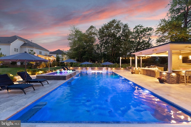18729 Upper Meadow Dr, Leesburg, VA 20176 - pool at dusk with a patio, an outdoor pool, an in-ground hot tub, and outdoor lounge area