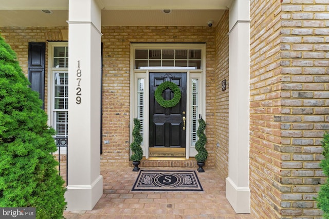 18729 Upper Meadow Dr, Leesburg, VA 20176 - doorway to property featuring brick siding and covered porch