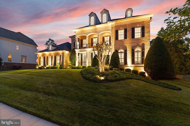 18729 Upper Meadow Dr, Leesburg, VA 20176 - colonial inspired home with a balcony, a front lawn, and brick siding