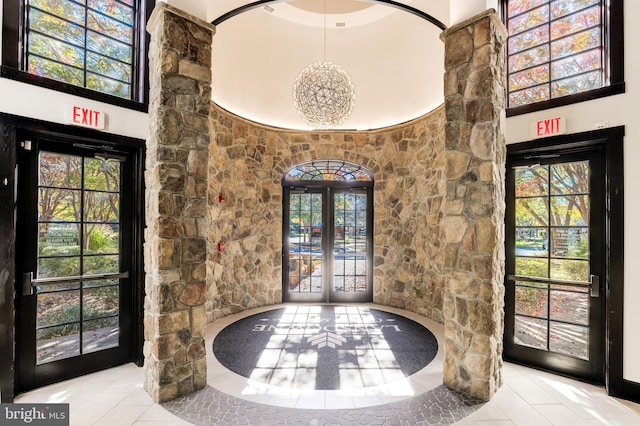18729 Upper Meadow Dr, Leesburg, VA 20176 - foyer entrance featuring tile patterned flooring, french doors, plenty of natural light, and a towering ceiling