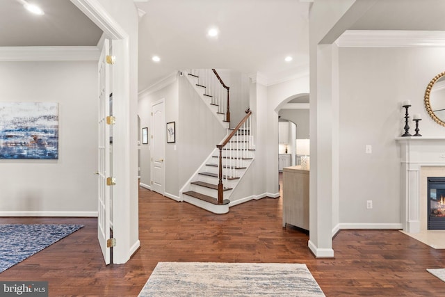 18729 Upper Meadow Dr, Leesburg, VA 20176 - foyer featuring ornamental molding, arched walkways, stairs, dark wood-type flooring, and baseboards