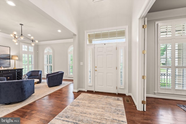 18729 Upper Meadow Dr, Leesburg, VA 20176 - entrance foyer featuring crown molding, a chandelier, dark wood-style flooring, baseboards, and recessed lighting