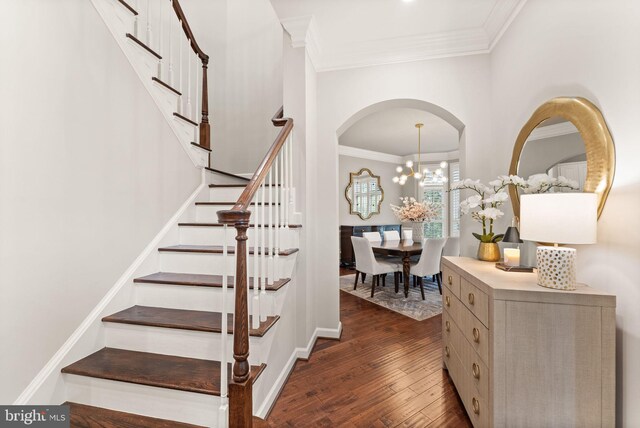 18729 Upper Meadow Dr, Leesburg, VA 20176 - stairs with wood-type flooring, crown molding, baseboards, a chandelier, and arched walkways