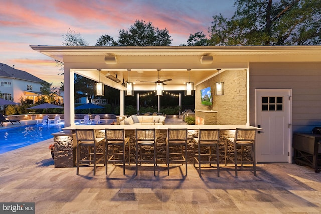 18729 Upper Meadow Dr, Leesburg, VA 20176 - patio terrace at dusk featuring ceiling fan and an outdoor pool
