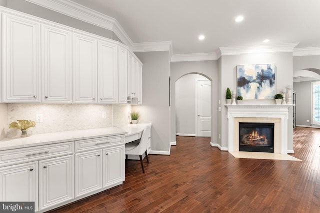 18729 Upper Meadow Dr, Leesburg, VA 20176 - home office featuring arched walkways, dark wood-style floors, ornamental molding, baseboards, and recessed lighting