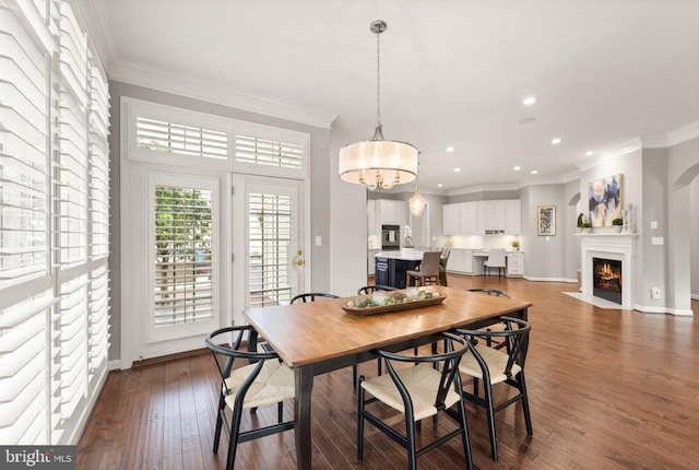 18729 Upper Meadow Dr, Leesburg, VA 20176 - dining room featuring wood-type flooring, recessed lighting, a fireplace with flush hearth, crown molding, and baseboards