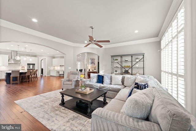 18729 Upper Meadow Dr, Leesburg, VA 20176 - living room featuring arched walkways, a ceiling fan, wood finished floors, recessed lighting, and crown molding