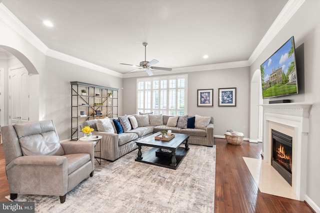 18729 Upper Meadow Dr, Leesburg, VA 20176 - living area with arched walkways, a premium fireplace, ceiling fan, dark wood-style floors, and ornamental molding