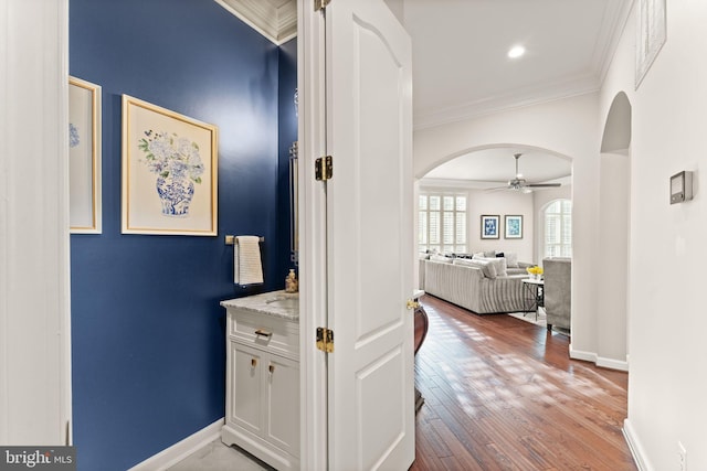 18729 Upper Meadow Dr, Leesburg, VA 20176 - hall featuring arched walkways, ornamental molding, light wood-style floors, and baseboards