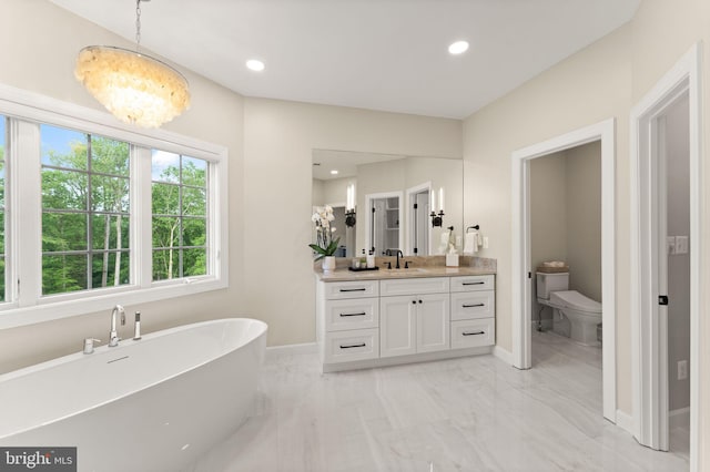 18729 Upper Meadow Dr, Leesburg, VA 20176 - bathroom featuring marble finish floors, vanity, a freestanding bath, toilet, and baseboards