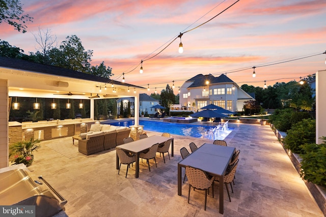 18729 Upper Meadow Dr, Leesburg, VA 20176 - pool at dusk featuring outdoor lounge area, outdoor dining space, a pool with connected hot tub, a patio, and ceiling fan