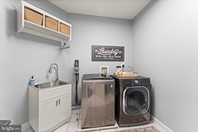 18729 Upper Meadow Dr, Leesburg, VA 20176 - laundry area featuring washer and clothes dryer, baseboards, light tile patterned flooring, and cabinet space
