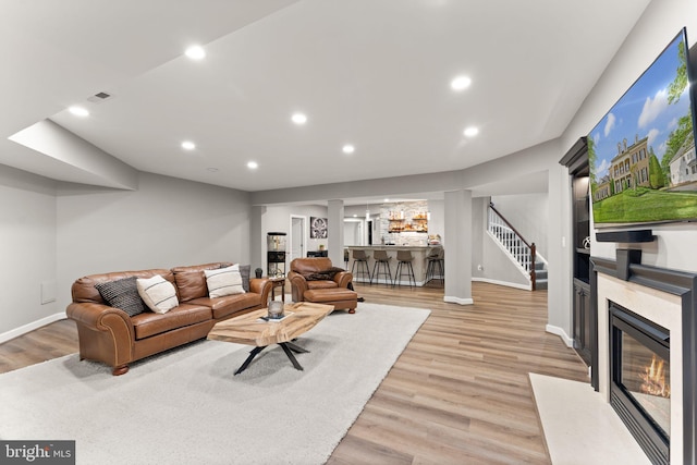 18729 Upper Meadow Dr, Leesburg, VA 20176 - living area with stairs, light wood finished floors, a high end fireplace, baseboards, and recessed lighting