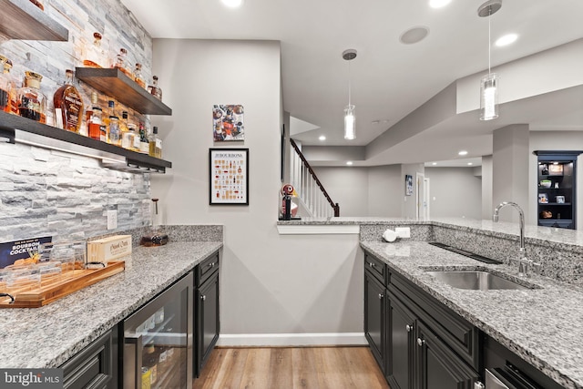 18729 Upper Meadow Dr, Leesburg, VA 20176 - indoor wet bar featuring wine cooler, light wood-type flooring, baseboards, decorative backsplash, and decorative light fixtures