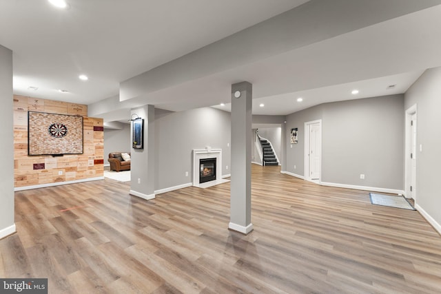 18729 Upper Meadow Dr, Leesburg, VA 20176 - finished basement with baseboards, recessed lighting, light wood-style flooring, stairs, and a glass covered fireplace