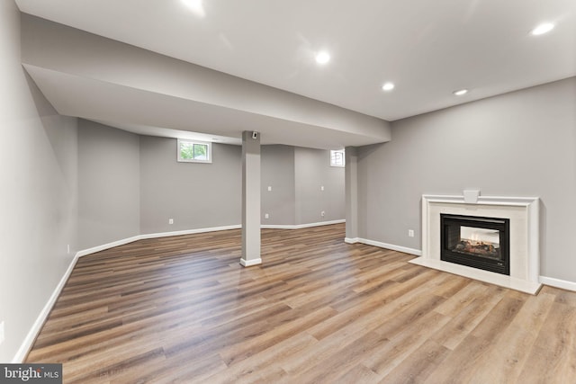 18729 Upper Meadow Dr, Leesburg, VA 20176 - below grade area with wood finished floors, baseboards, recessed lighting, and a fireplace
